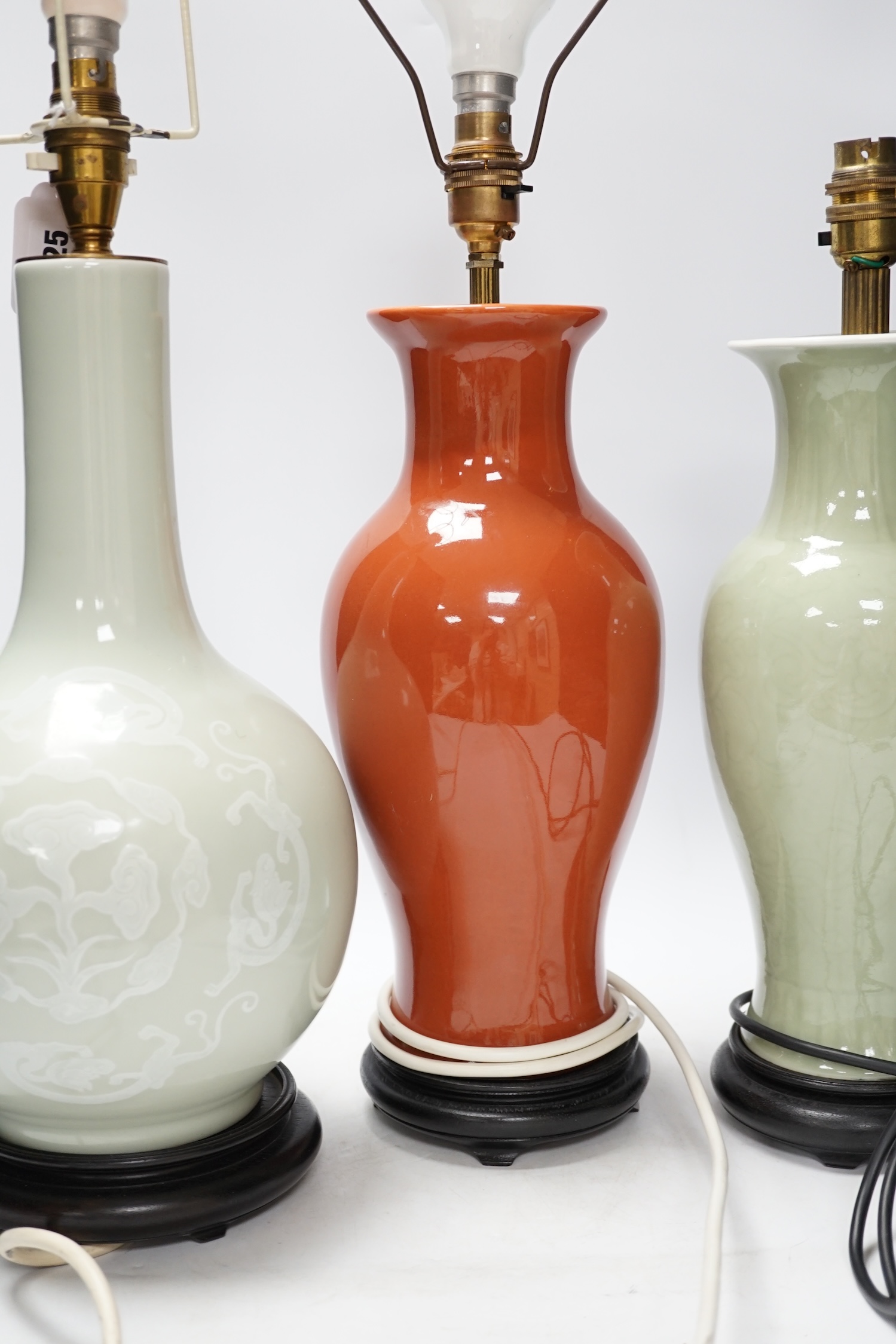 Three Chinese monochrome porcelain lamp bases, 20th century, tallest 38cm high